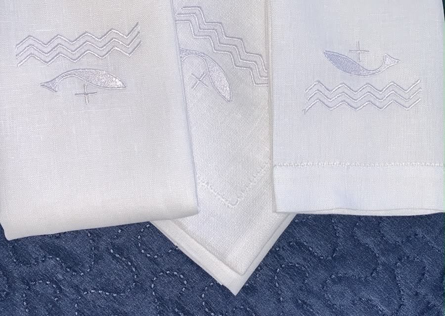 Panos de linho bordados com peixes, o barco e as ondas, os sinais antigos dos cristãos.